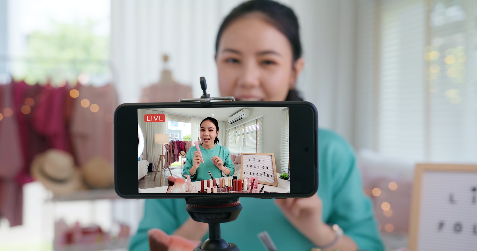 Asia woman micro influencer record live viral video camera at home studio.